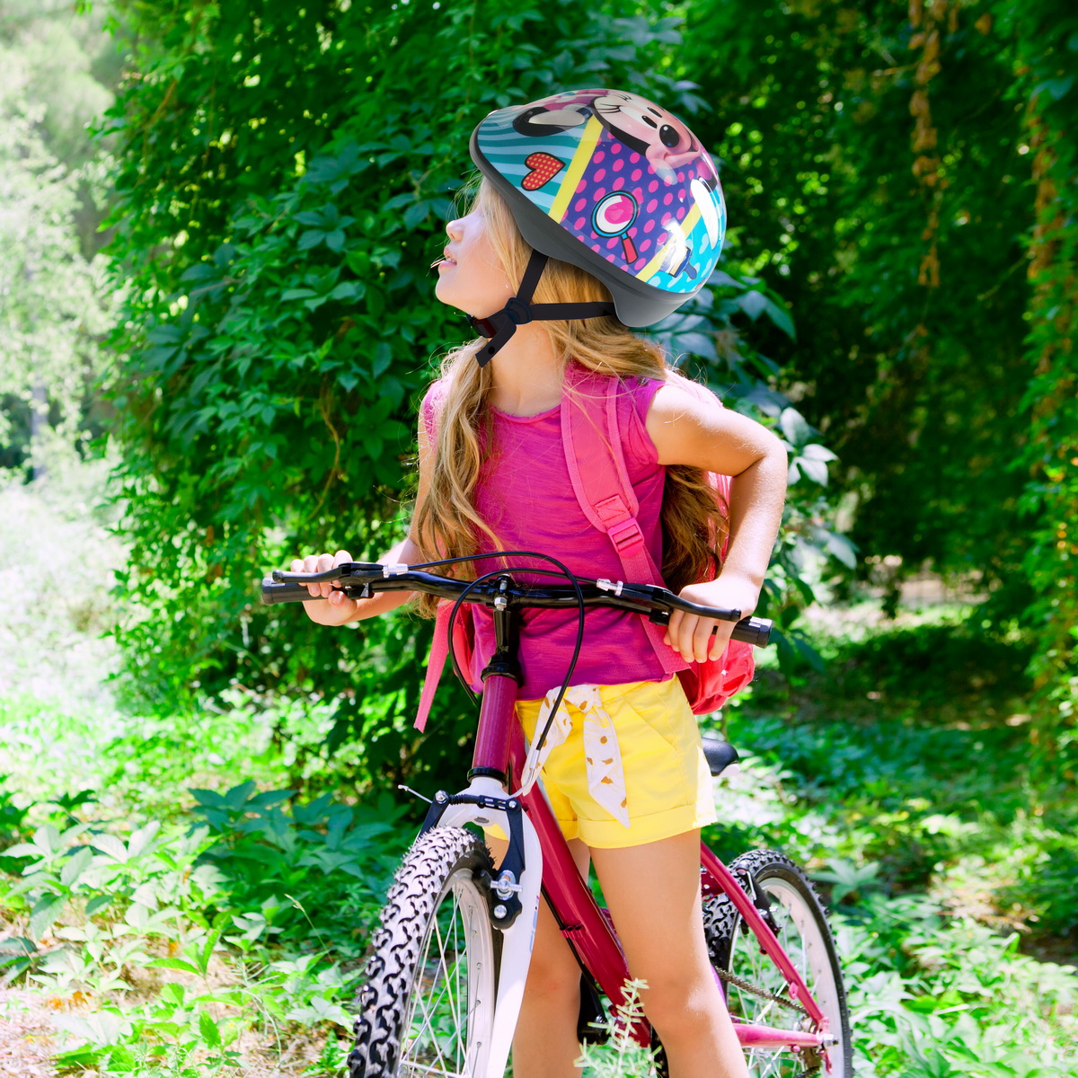 Children girl riding bicycle outdoor in forest smiling