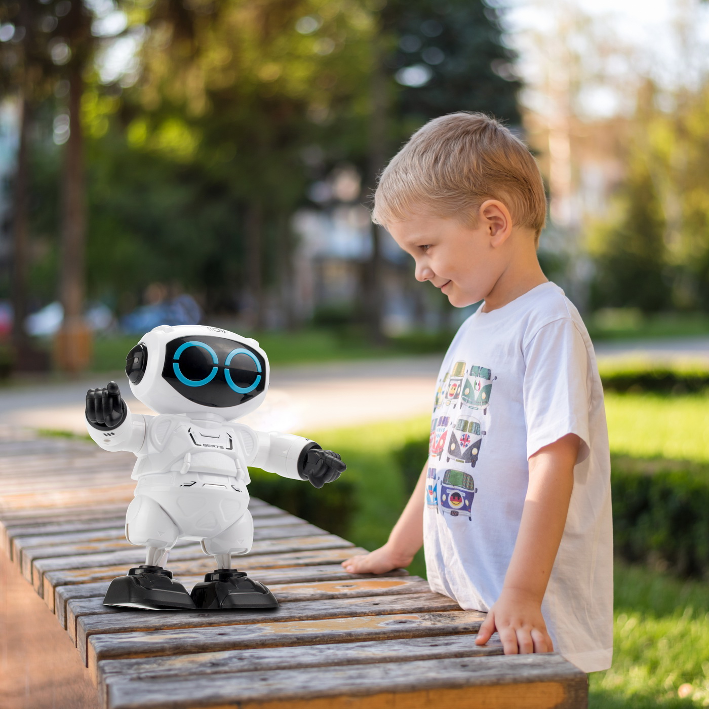 little boy playing outside with a robot