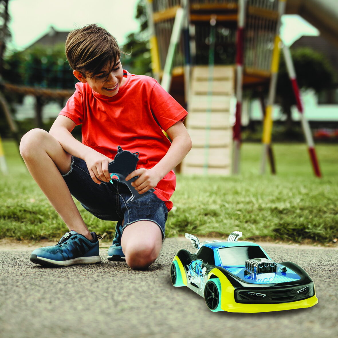 teen boy with electric remote control car toy play outdoor on si