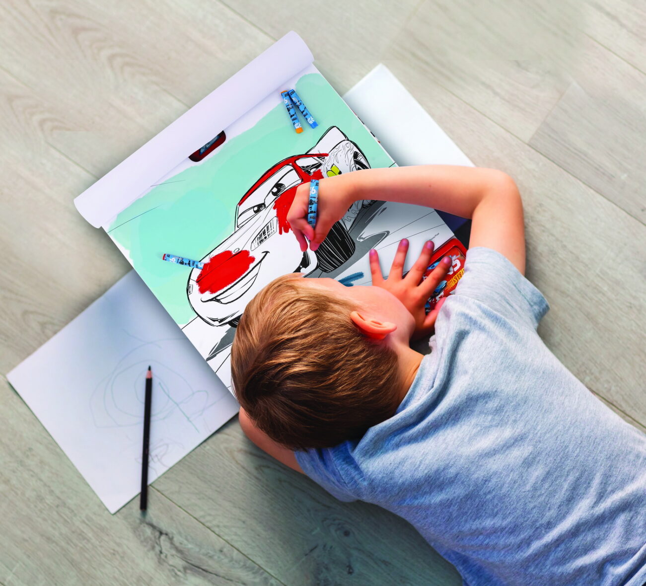 Little boy drawing on the floor in his room