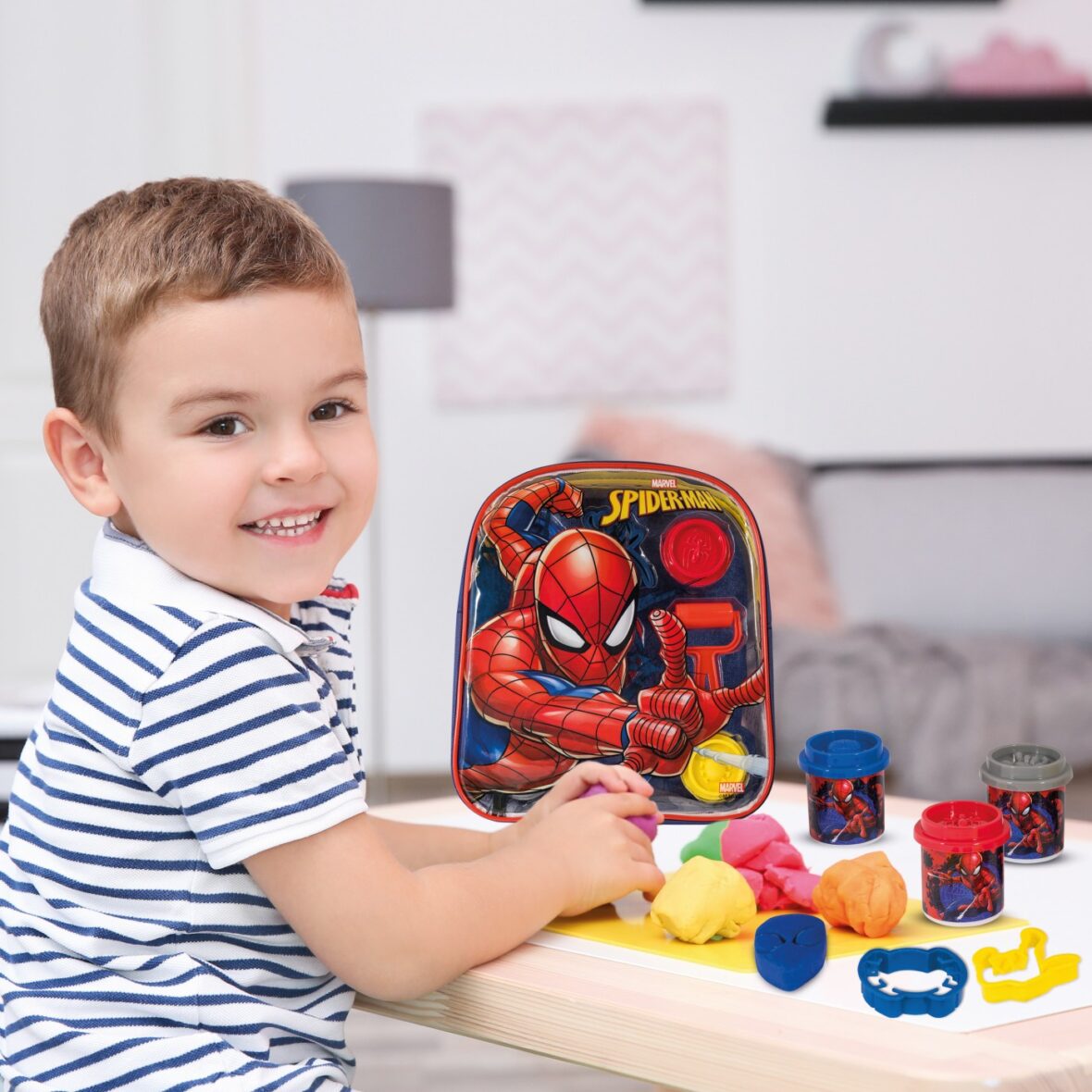 Cute little boy modeling from playdough at home